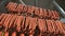 Hunting sausages close - up which is suspended on the shelves, dries in the storage room. Panorama of the sausage which