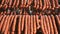 Hunting sausages close - up which is suspended on the shelves, dries in the storage room. Panorama of the sausage which