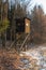 Hunting tower in wild forest. Wooden Hunter Hide High watch post tower. Hunter`s observation point in forest in Europe. Czech