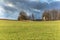 Hunting watchtower at the edge of the field. Dramatic sky. Hunting evening. Agricultural landscape in the Czech Republic. Hunting