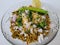 Hurda, Tender Jowar or Sorghum Bhel served in a bowl with green chilly and lemon. Selective focus