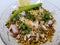 Hurda, Tender Jowar or Sorghum Bhel served in a bowl with green chilly and lemon. Selective focus