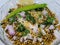 Hurda, Tender Jowar or Sorghum Bhel served in a bowl with green chilly and lemon. Selective focus