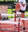 Hurdler practicing a-skip drill over hurdles