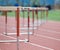 Hurdles lined up on a track, fading focus