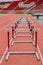 Hurdles on red running track in stadium