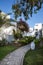 Hurgada, Egypt - 11 August 2014: white wall hotel entrance area with path, palms in the idyllic green garden