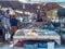 Hurgada, Egypt - February 2020: stack full of fish and other sea food, medium view. Street market full of people