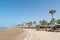 Hurghada / Egypt - July 20, 2019: Sandy beach with palm trees and parasols in Golden Beach / Movie gate resort