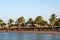 Hurghada / Egypt - July 20, 2019: Sandy beach with palm trees and parasols in Golden Beach / Movie gate resort