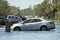 Hurricane flooded street with broken car in surrounded with water Florida residential area. Consequences of natural