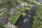 Hurricane flooded street with moving cars and surrounded with water houses in Florida residential area. Consequences of