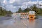 Hurricane flooded street with road closed signs blocking driving of cars. Safety of transportation during natural