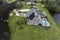 Hurricane Ian destroyed house with damaged roof and lanai enclosure over swimming pool in Florida residential area