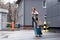 hurrying businesswoman with suitcase checking time and running