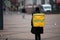 Hurrying delivery man of Ukrainian Glovo. delivery service in Kiev, Ukraine, 9 Mar h 2020. back side view,motion blurry
