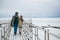 The husband arranged an exit date for his wife in the winter on the river pier in the snow, they enjoy each other