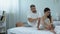 Husband comforting wife in bed, couple trying to get pregnant without success