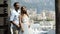 Husband embraces wife in background of city. Action. Young beautiful couple embracing on cityscape background. Newlyweds