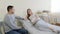 The husband holds his wife's hand, visits his pregnant wife in a private clinic during a medical examination. A