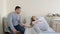 The husband holds his wife's hand, visits his pregnant wife in a private clinic during a medical examination. A