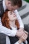 The husband kisses his wife on the forehead. A young couple. Happy redhead husband and wife.