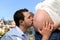 Husband kissing pregnant belly of his wife