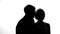 Husband kissing wife on cheek and smiling, newlyweds enjoying each other, flirt