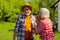 Husband laughing while blowing at dandelion with wife