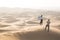 A husband photographs his wife in the desert.