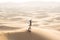 A husband photographs his wife in the desert.