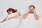 Husband plugs ears with hands due to noise and snoring of sleeping wife. Family relationships in isolation due to coronavirus