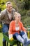 Husband pushing wife in a wheelbarrow