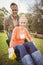 Husband pushing wife in a wheelbarrow