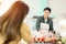 Husband slicing vegetables to prepare breakfast. With a young wife supporting him In a romantic atmosphere