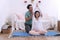 Husband take care wife pregnant help exercise by yoga in living room at home. Pregnancy couple healthcare and relationship