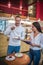 Husband trying dessert while having degustation of sweets with wife