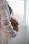 Husband uses hand to touch belly of pregnant wife in white dress, with soft sunlight In morning relaxed atmosphere,concept