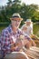 Husband wearing glasses enjoying yummy sandwich while having boat trip