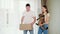 Husband and wife carry box and cute cat to new house