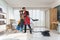 Husband and wife couple have fun do housework together