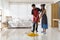 Husband and wife couple have fun do housework together