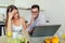 Husband and wife doing paperwork together, paying taxes online on laptop