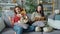 Husband and wife enjoying books at home and caressing adorable corgi puppy