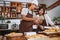 Husband and wife get donut orders while cooking to make donuts