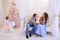 Husband and wife give each other Christmas gifts in bright spaci