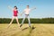 Husband, wife in jump in field