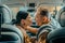 Husband and wife smiling before kissing in the car.