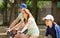 Husband with wife and son riding bicycles in park