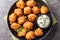 Hush puppies is made with eggs, onion, self-rising flour, and cornmeal, then deep-fried until crisp and golden closeup on the